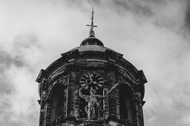 Free Photo low angle greyscale shot of the royal palace at the dam square in amsterdam, netherlands