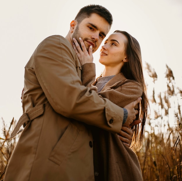 Free photo low angle happy couple posing