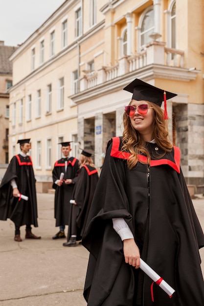 Free Photo low angle happy girl graduated