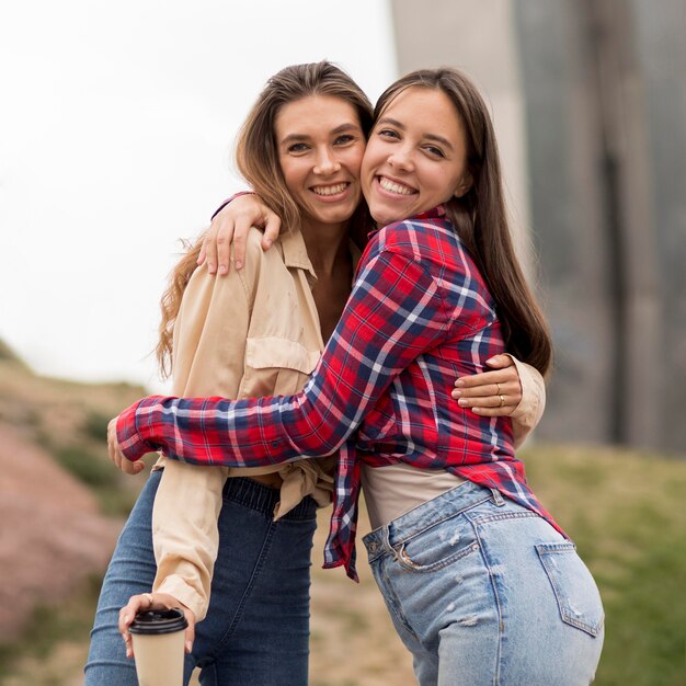 Low angle happy girls hugging