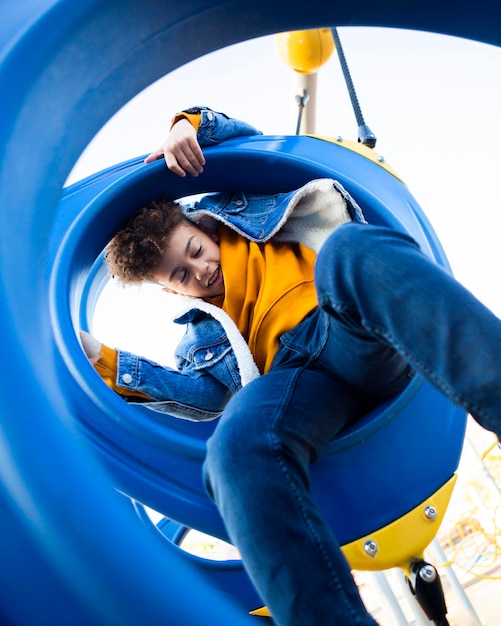 Low angle kid having fun at the playground