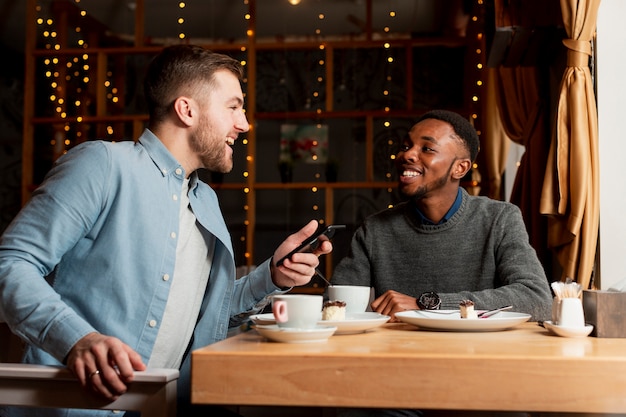 Low angle male friends at restaurant