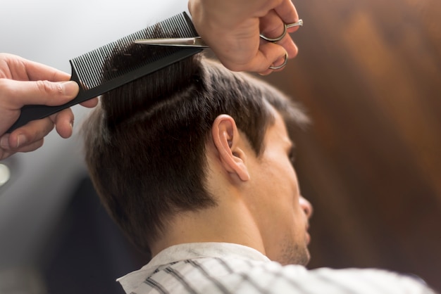 Low angle man getting a haircut