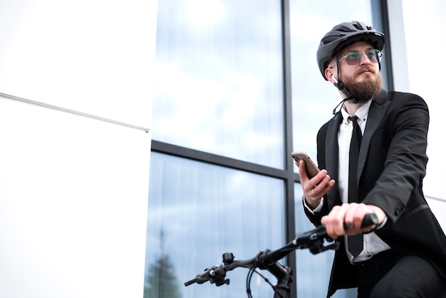 Free Photo low angle man holding smartphone