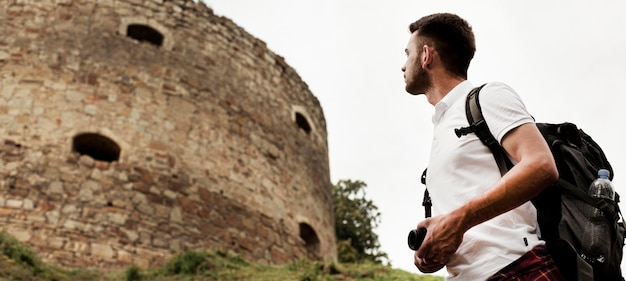 Free photo low angle man looking at castle