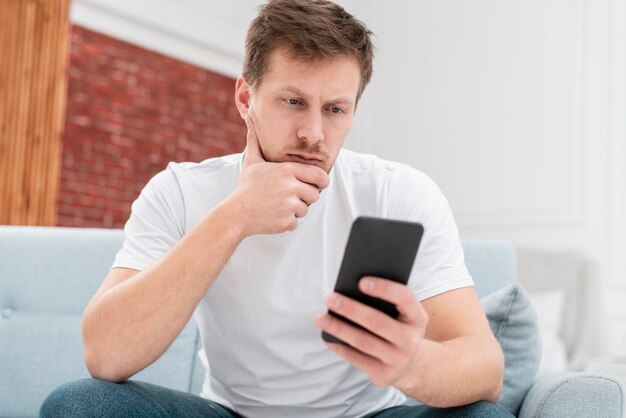 Low angle man looking on his feed