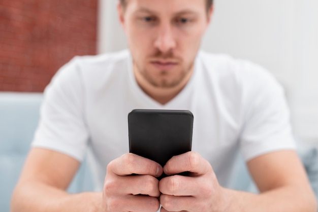 Low angle man scrolling the internet