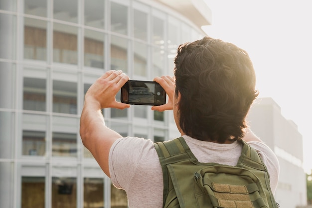 Free photo low angle man taking photos