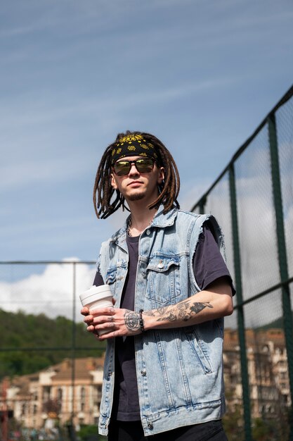 Low angle man with afro dreadlocks posing