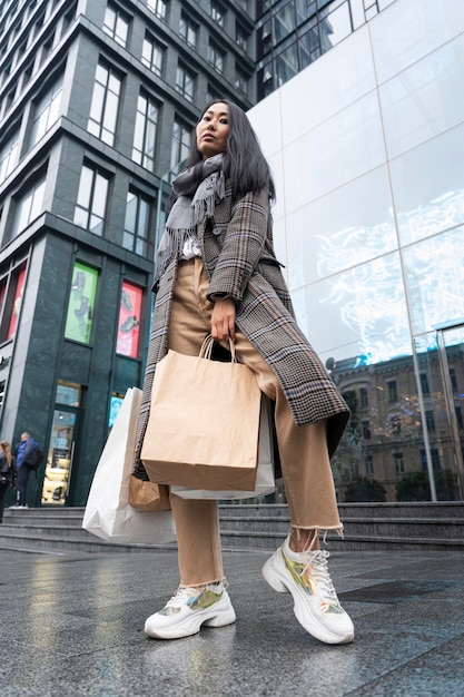 Low angle model holding shopping bags