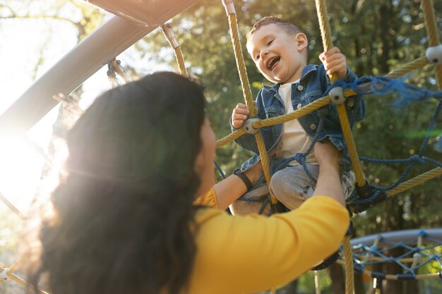 Low angle mother and happy boy in park