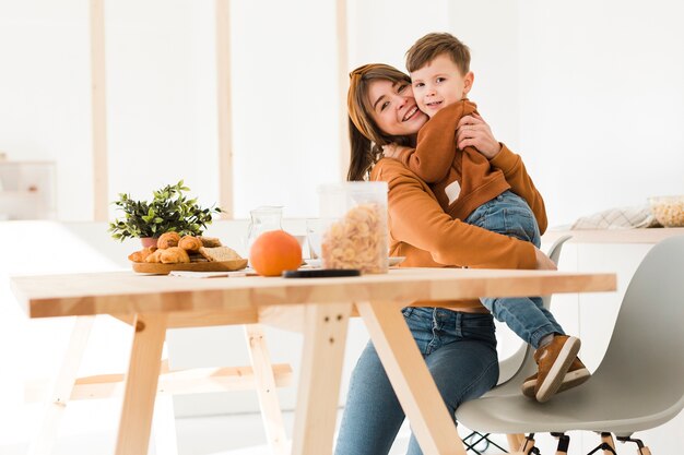 Low angle mother hugging her son