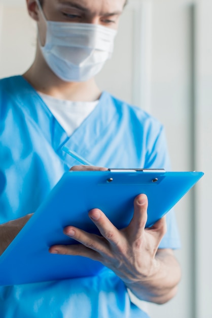 Low angle nurse male with clipboard