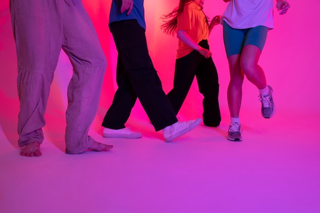 Free photo low angle people dancing in studio