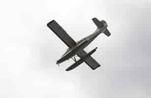 Free photo low angle picture of a seaplane flying over the clear sky