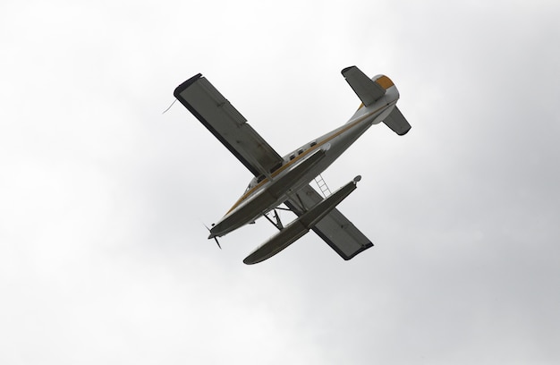 Free Photo low angle picture of a seaplane flying over the clear sky