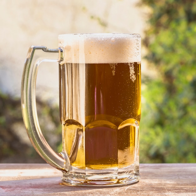 Low angle pint with foaming beer on table