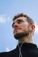 Free photo low angle portrait of a man looking away