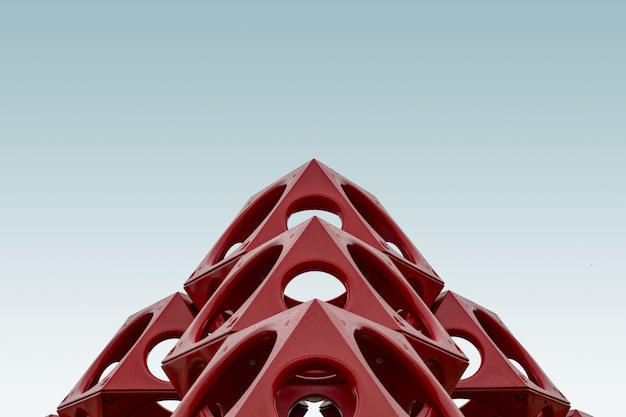 Free photo low angle of a red geometrical structure under the blue sky