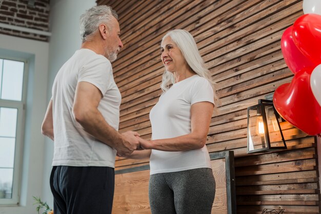 Low angle senior couple holding hands