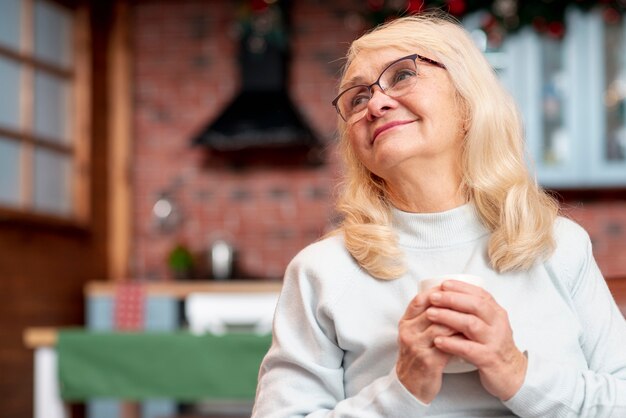 Low angle senior woman drinking tea