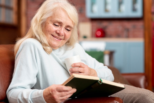 Free Photo low angle senior woman lecture at home