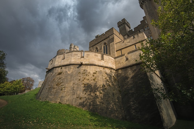 Free Photo low angle shot of the arundel castle and cathedral surrounded by beautiful foliage