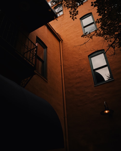 Free Photo low angle shot of a brown building with vertical windows