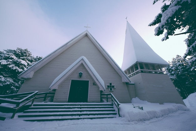 Free photo low angle shot of a chapel covered with thick snow in winter