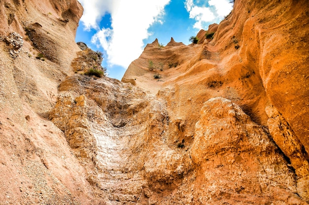 Low angle shot of cliffs under a blue sky in Umbria, Italy