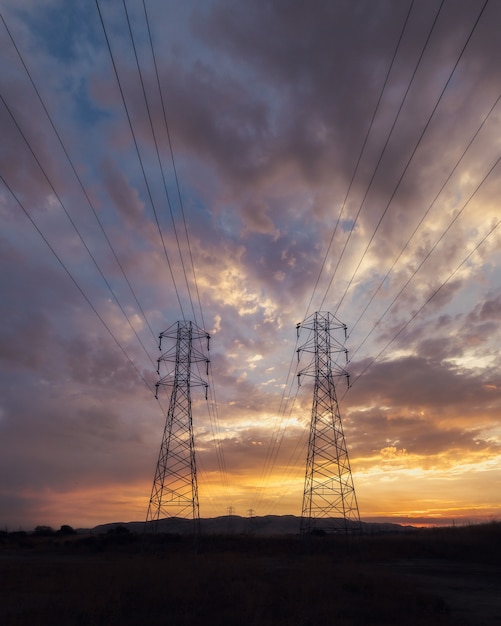 Free Photo low angle shot of electricity wires under a beautiful sunset sky