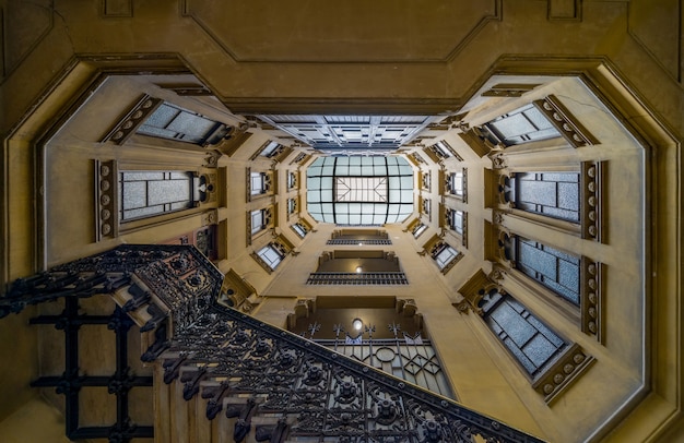 Low angle shot of the geometrical stairway of an old building