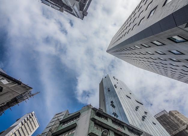 Free photo low angle shot of high residential buildings under the cloudy sky