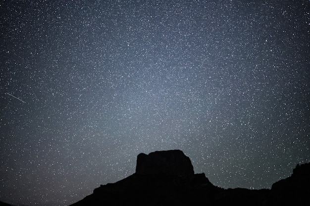 Free Photo low angle shot of a hill under a beautiful starry night sky