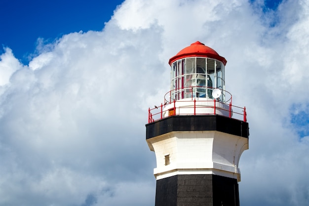 Low angle shot of a lighthouse under the beautiful cloud in the sky