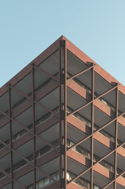 Free photo low angle shot of a modern building in the middle of the city under the clear sky