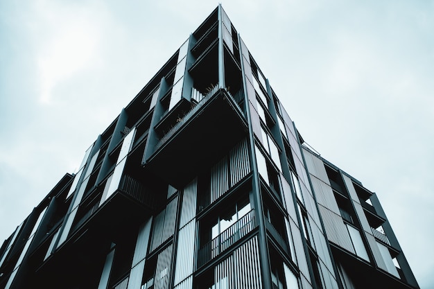 Free Photo low angle shot of a modern building with glass windows