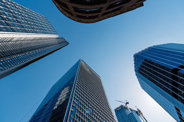 Low angle shot of the modern glass buildings and skyscrapers on a clear day