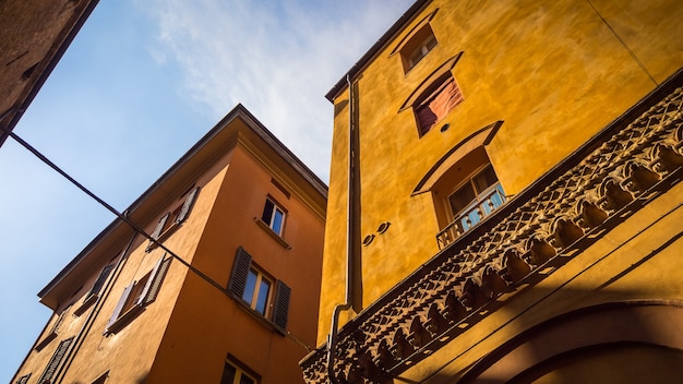 Low angle shot of orange buildings with windows in Italy