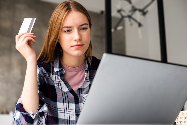 Free photo low-angle shot of woman looking at laptop