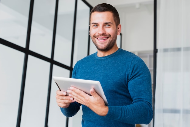 Low angle smilet man with tablet