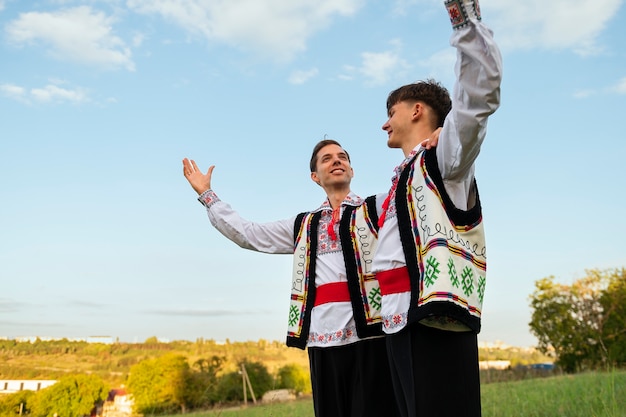 Free photo low angle smiley men with traditional clothes