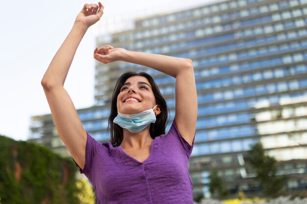 Low angle smiley woman outdoors