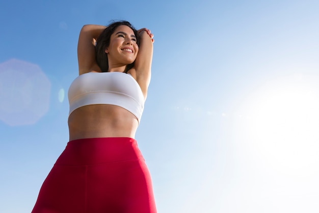 Low angle smiley woman outdoors