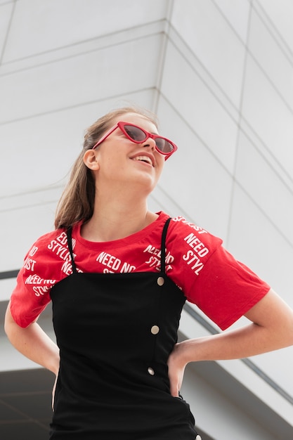 Low angle smiley woman with sunglasses