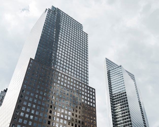 Free Photo low angle tall buildings with grey clouds