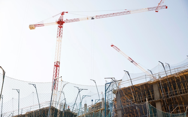 Low angle view of construction site against blue sky