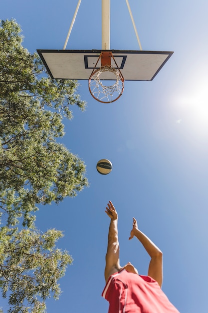 Free Photo low angle view of shooting basketball player