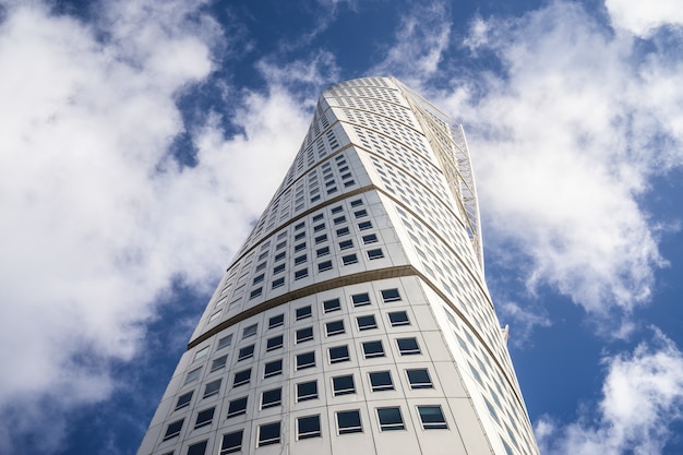 Low angle view of the Turning Torso under a blue sky and sunlight in Malmo in Sweden