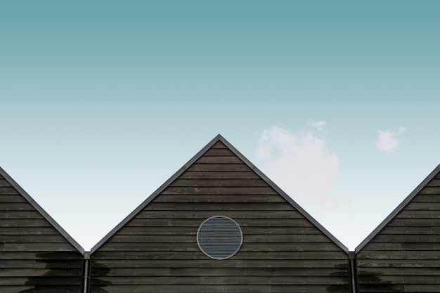 Free Photo low angle view of the wooden brown houses under the blue sky